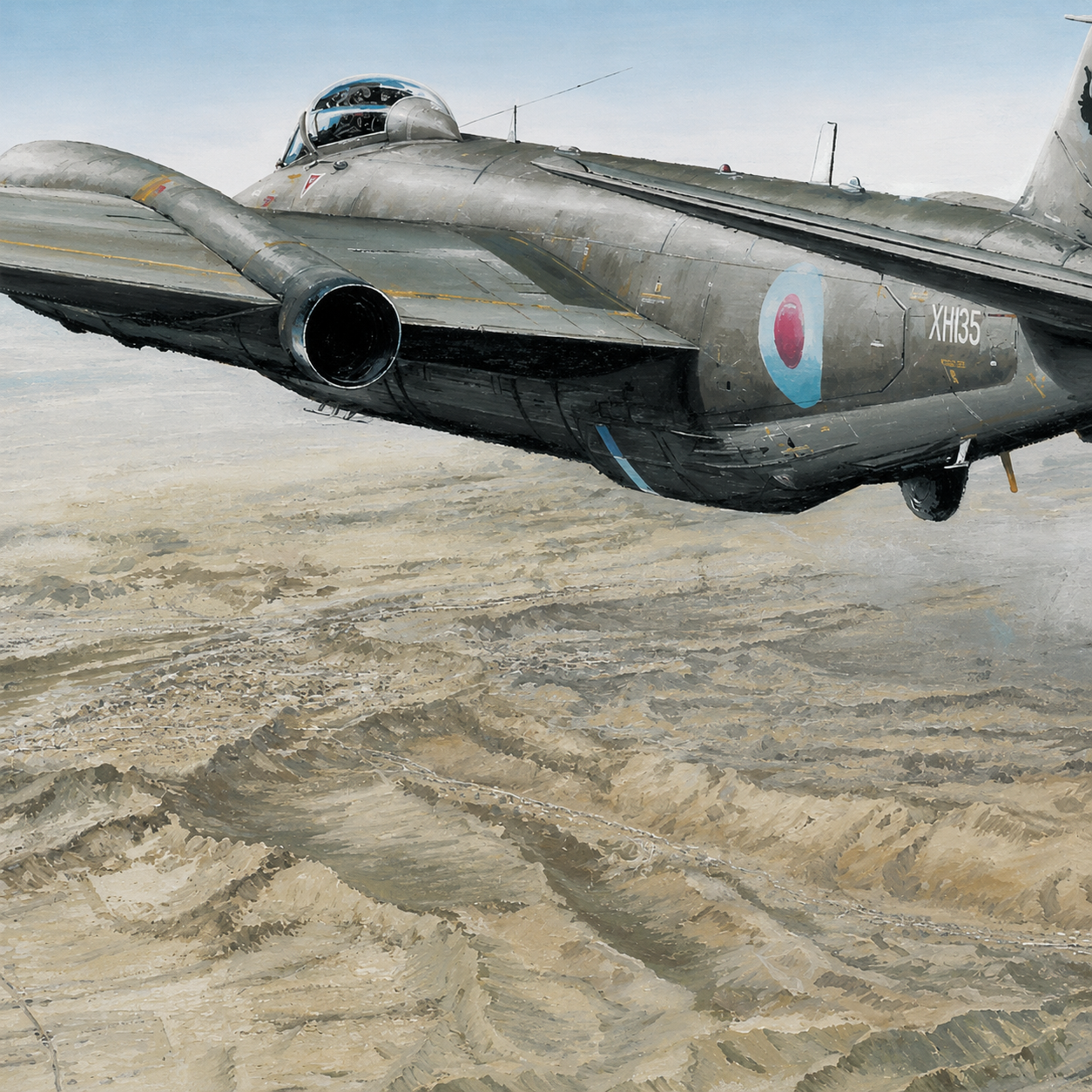 Canberra over Kabul Close Up 3 - Jet Art Gallery Gray military jet with a bubble canopy flying low over a sandy desert landscape, tail number XH135 visible.