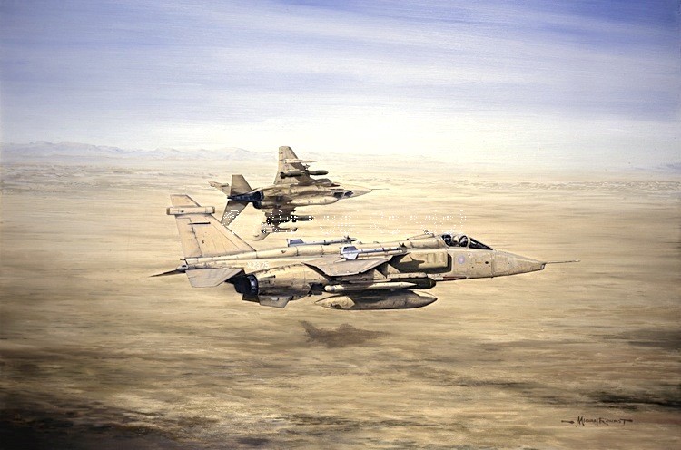Two military fighter jets fly in formation over a desert landscape, with the lead aircraft carrying missiles under its wings.