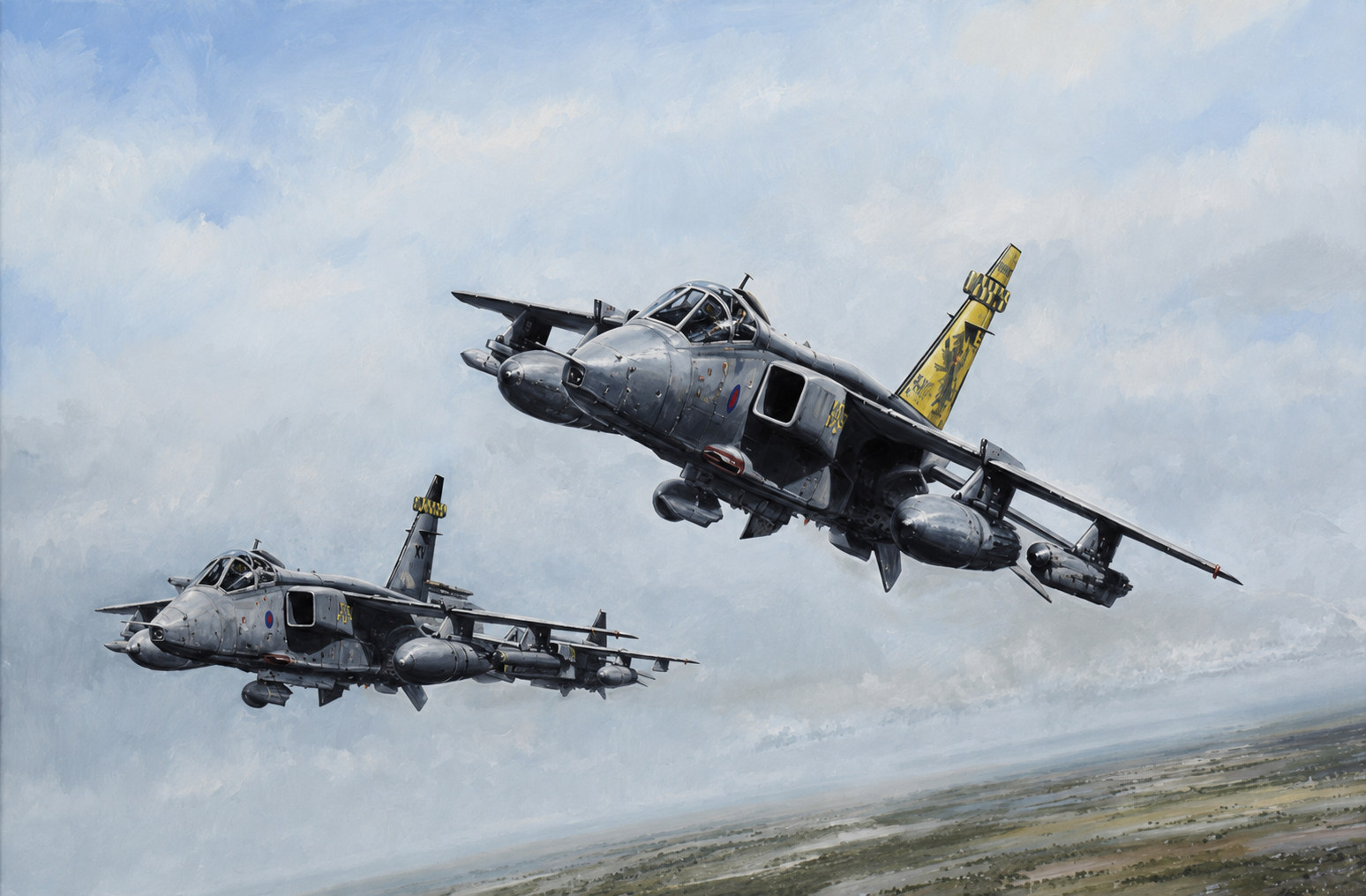 Two gray military jets in formation flying over a flat landscape, with visible payloads mounted under the wings and a bright yellow-tail artwork on the right aircraft.