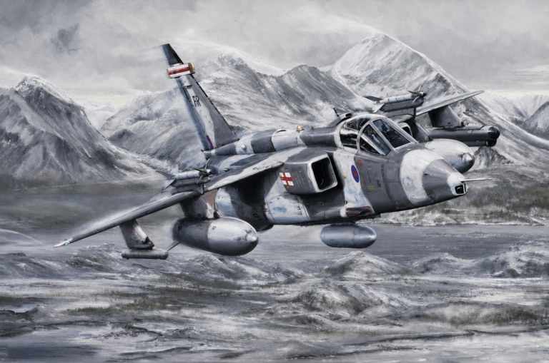 Grey military jet flying low over snow-covered mountains with a rugged, wintry landscape in the background, cockpit visible.