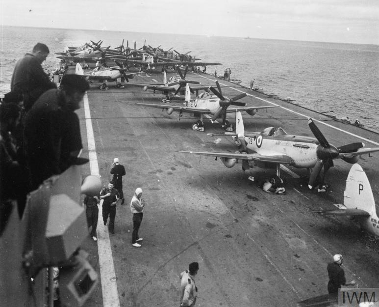 Seafire F.R.47 fighters and Fairey Firefly aircraft on the flight deck of HMS Triumph during the Korean War, 1950
